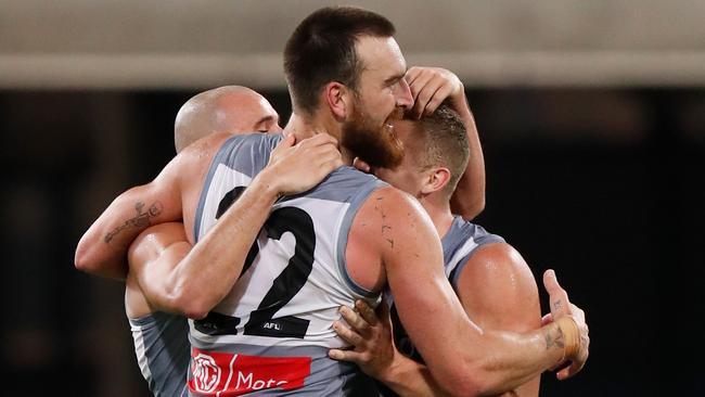 Sam Powell-Pepper, Charlie Dixon and Dan Houston celebrate the Power’s win over Collingwood. Picture: AFL Photos