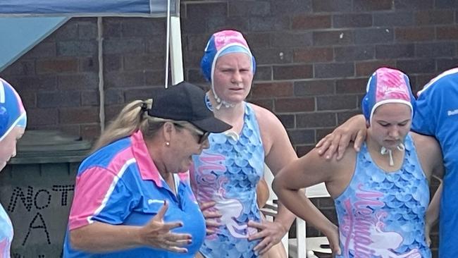 Merlo Mermaids' Matilda Moore, middle, listens to coach Nicola Johnson.