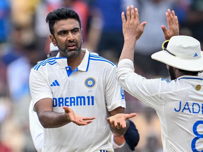 India's Ravichandran Ashwin (L) celebrates with his teammate Ravindra Jadeja after the dismissal of Bangladesh's Mushfiqur Rahim during the third day of the first Test cricket match between India and Bangladesh at the M.A. Chidambaram Stadium in Chennai on September 21, 2024. (Photo by R.Satish BABU / AFP) / -- IMAGE RESTRICTED TO EDITORIAL USE - STRICTLY NO COMMERCIAL USE --