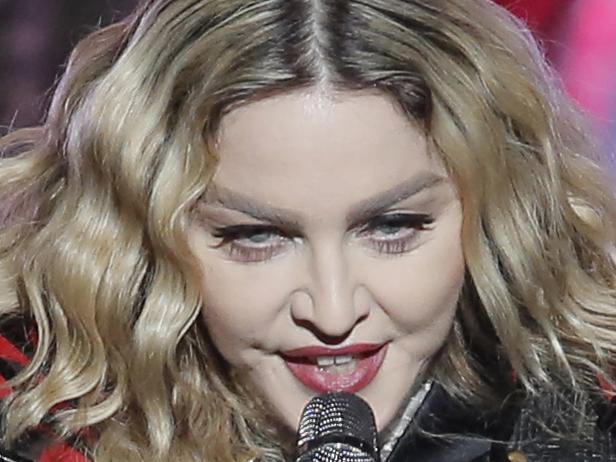 FILE - In this Feb. 20, 2016 file photo, Madonna performs during the Rebel Heart World Tour in Macau, China. Madonna says she would never perform at a concert “high or drunk” in an Instagram post early Tuesday, March 15, 2016. The pop star played off the reported rumors that she appeared drunk onstage during her current world tour. (AP Photo/Kin Cheung)