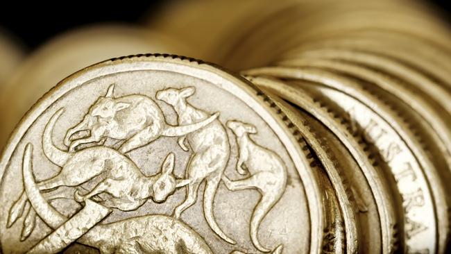 Australian one dollar coins over black background.