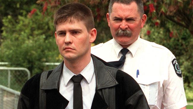 Damon John Karger being escorted to the murder scene in Campbelltown in 2000.