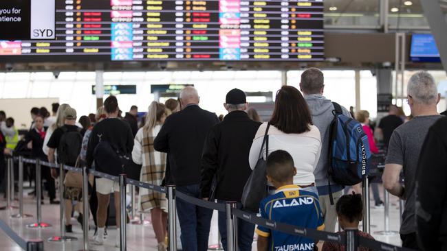 Public Holiday travellers queue and wait at Sydney Domestic Airport last week. Picture: NCA NewsWire / Nikki Short