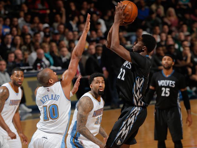 Andrew Wigginsof the Minnesota Timberwolves takes a shot over Arron Afflalo of the Denver Nuggets.