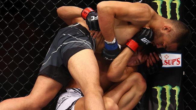 Josh Culibao (top) gets to work on Seungwoo Choi in their featherweight bout during UFC 275 at Singapore Indoor Stadium. Pictures: Getty Images