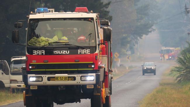 Three mile fire: Rural Fire Service truck moves through the smoke near the Three Mile fire.