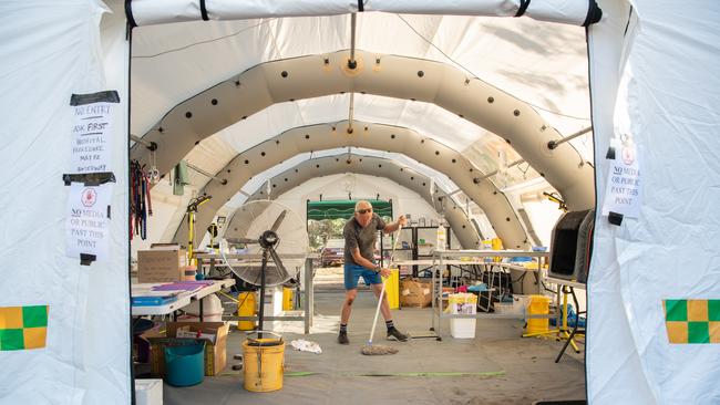 Grant Jenson mops the floor of the inflatable animal hospital at Kangaroo Island Wildlife Park. Picture: Brad Fleet