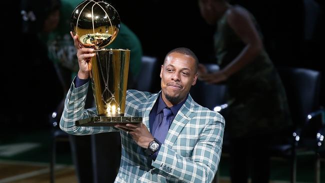 Former Boston Celtic Paul Pierce holds the NBA championship trophy that he won with the team during a ceremony to retire his number.