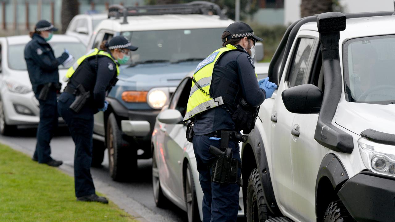 Police chat to drivers at a random checkpoint in Port Melbourne. Picture: Andrew Henshaw