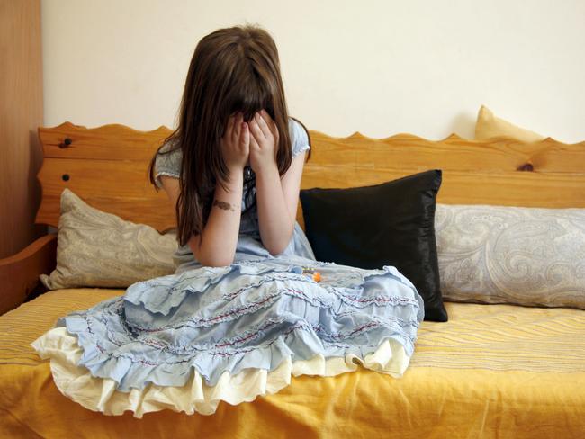 Sad girl on a sofa. Child. Generic image.