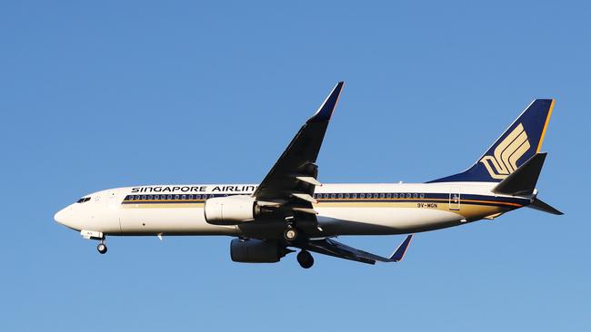 A Singapore Airlines passenger jet plane flies into the Cairns International Airport. Picture: Brendan Radke