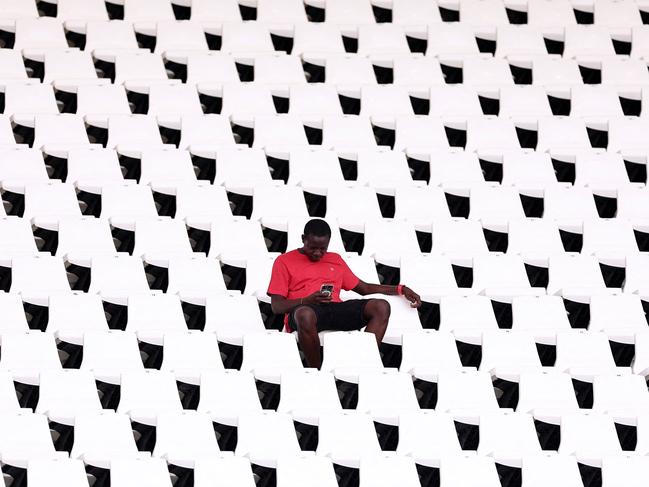 A supporter looks at his phone prior to an Africa Cup of Nations 2024 football match between Egypt and Mozambique. Picture: Franck Fife/AFP