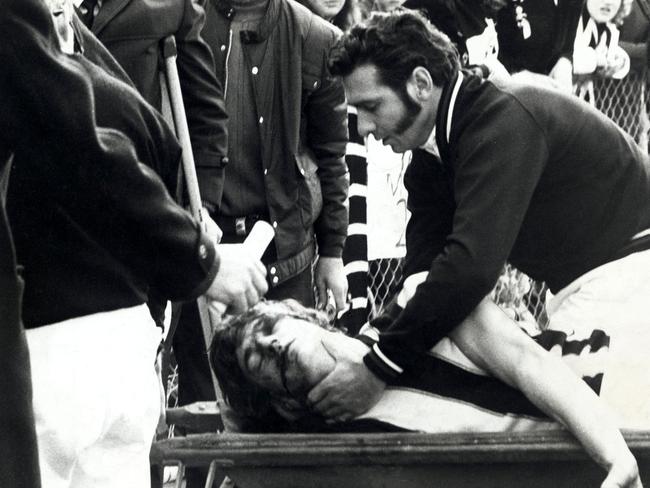 A trainer attends to Collingwood’s John Greening.