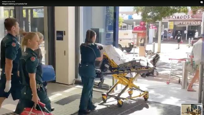 A man taken by stretcher to an ambulance at the crime scene in Australia Fair.