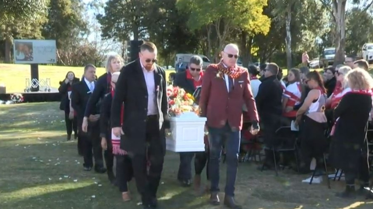 Mr McBride carries his wife and daughter’s casket to the hearse after their celebration of life. Picture: Belinda Jane Video