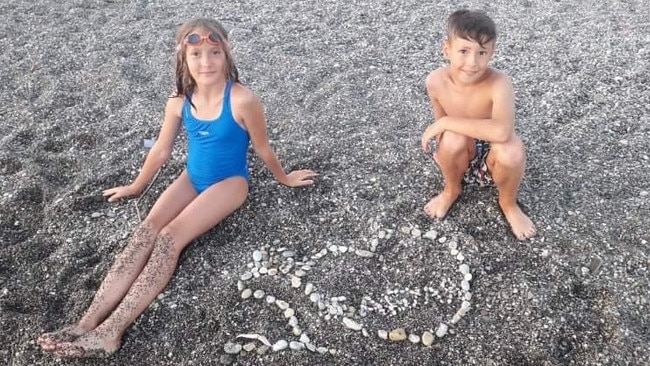 Kyrylo and Anastasiia making shell art at the beach before the Russian invasion.