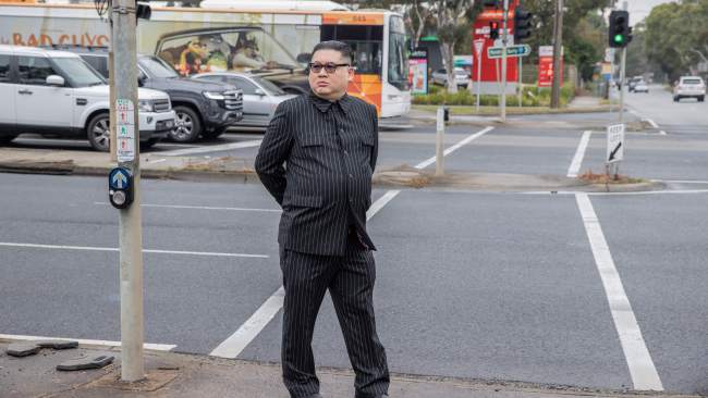 The impersonator is seen standing outside the press event. Picture: Jason Edwards