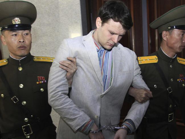 FILE - In this March 16, 2016, file photo, American student Otto Warmbier, center, is escorted at the Supreme Court in Pyongyang, North Korea. President Donald Trump says he doesn't think North Korean leader Kim Jong Un was involved in the mistreatment of American college student Otto Warmbier, who died after being detained in the North. Trump says of Kim: "He tells me that he didn't know about it, and I will take him at his word." The Ohio native was sentenced to 15 years of hard labor in North Korea on suspicion of stealing a propaganda poster. Warmbier died in 2017, shortly after being sent home in a coma.  (AP Photo/Jon Chol Jin, File)