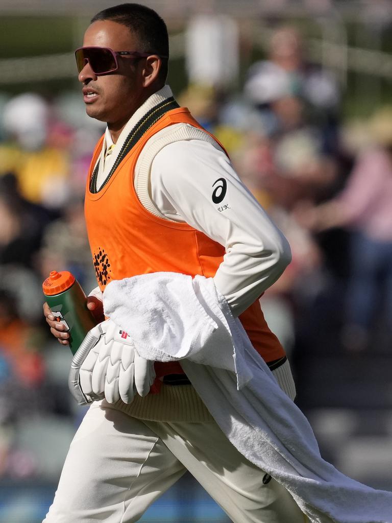 Khawaja takes drinks off the field during the Adelaide Test.