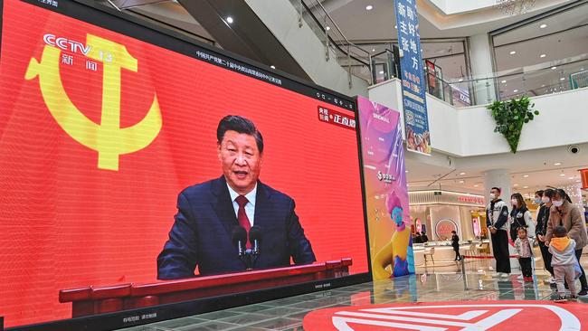 People watch a live broadcast of Xi Jinping speaking during the introduction of the CCP Politburo Standing Committee, at a shopping mall in Qingzhou in China's eastern Shandong province. Picture: AFP.