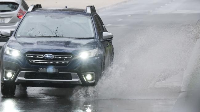 A car drives through water in Geelong on Sunday afternoon. Picture: Mark Wilson