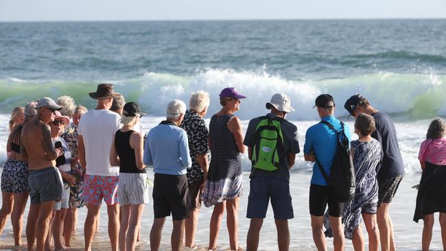 Bribie Island locals gather to pay respects to 17 year old shark attack victim Charlie Zmuda at Woorim Beach on Tuesday morning. Picture Lachie Millard