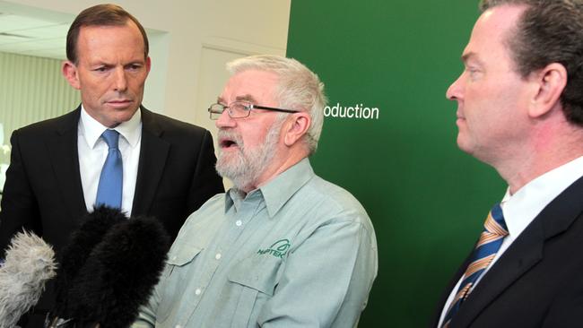 Then federal opposition leader Tony Abbott and fellow Liberal MP Christopher Pyne listen to Dr Bob Johnson during a visit to Adelaide in 2012. 