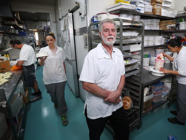 17/7/18: Owner and operator of Boronia Bakehouse in Hunters Hill, Rob Wall with pastry chefs Scott Jones (left), Greta Wall (holding the cake) and Tanya Bhatti. Rob is unhappy that TAFE courses, as little as 18 weeks long, are giving students the same qualifications as its four-year apprenticeships. John Feder/The Australian.