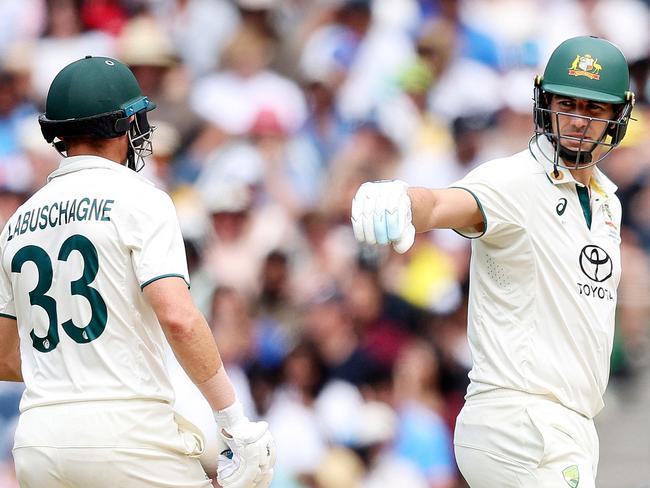 Australia's Pat Cummins (R) and Australia's Marnus Labuschagne interact between overs on day four of the fourth cricket Test match between Australia and India at the Melbourne Cricket Ground (MCG) in Melbourne on December 29, 2024. (Photo by Martin KEEP / AFP) / -- IMAGE RESTRICTED TO EDITORIAL USE - STRICTLY NO COMMERCIAL USE --