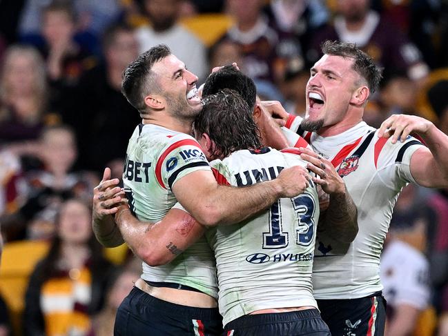 BRISBANE, AUSTRALIA - MAY 03: TerrellÃÂ May of the Roosters is congratulated by team mates James Tedesco, ConnorÃÂ Watson and AngusÃÂ Crichton of the Roosters after scoring a try during the round nine NRL match between the Brisbane Broncos and Sydney Roosters at Suncorp Stadium, on May 03, 2024, in Brisbane, Australia. (Photo by Bradley Kanaris/Getty Images)