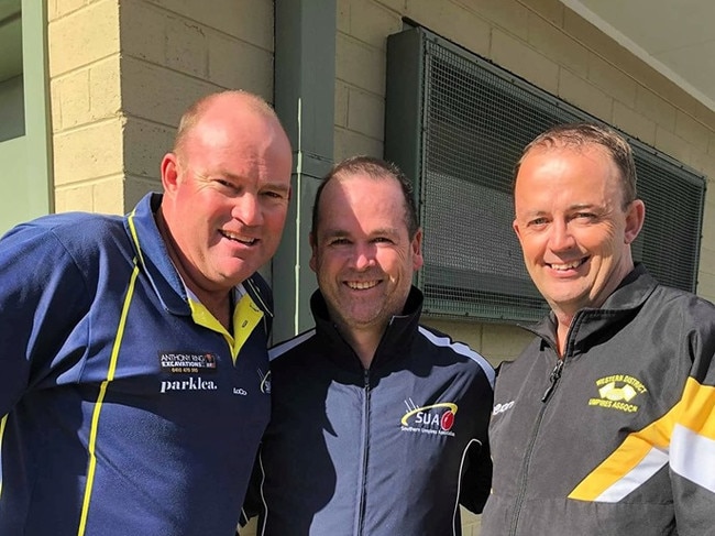 Jason Hughes (far right) returned to the MPNFL to umpire his 500th game alongside Brett Gent (left) and