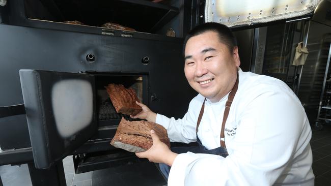 5B2F owner Mr Moonsun Yoo at his wood fired oven. Picture Mike Batterham