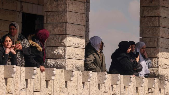 Palestinian women watch from a balcony during the funeral of a 17-year-old who died of wounds sustained a day earlier during an Israeli raid in the occupied West Bank. Picture: AFP