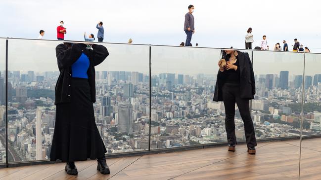 A fun angle captures girls taking selfies who are reflected in the structure on the panoramic rooftop bridge of the Shibuya Scramble building in Tokyo. Picture: Doron Talmi