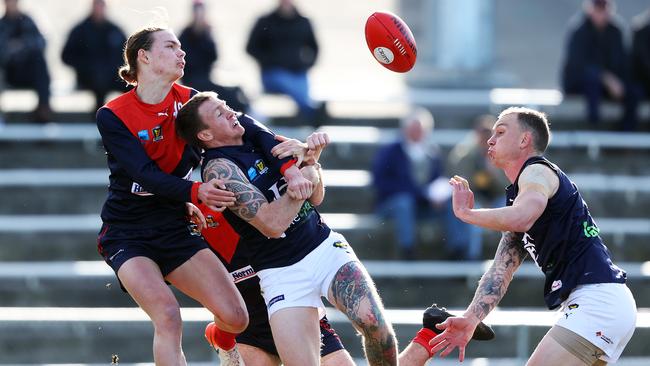 North Hobart's Samuel Collins spoils the mark of Launceston's Dylan Riley. Picture: Zak Simmonds