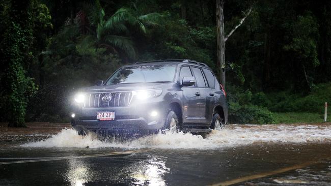 A 4WD vehicle drives through floodwater on Tallebudgera Connection Road at the back of Currumbin Creek after torrential rain over night caused the creek to break its banks. NCA NewsWire / Scott Powick
