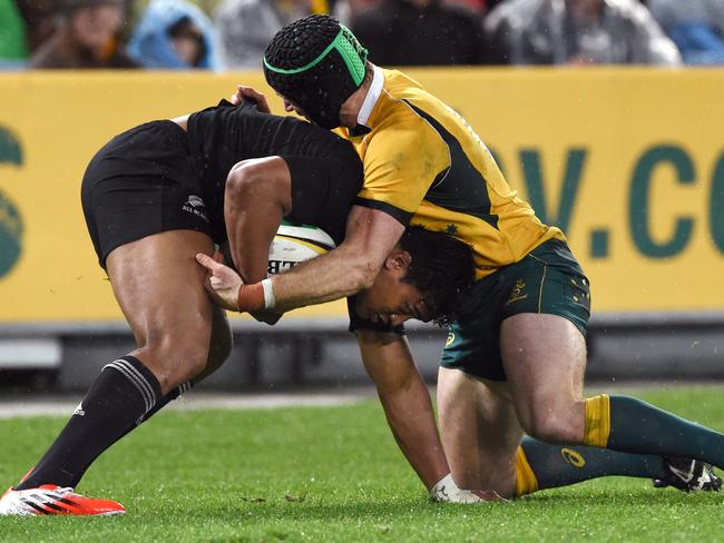 Pat McCabe tackles Julian Savea during the 2014 Bledisloe Cup match in Sydney.