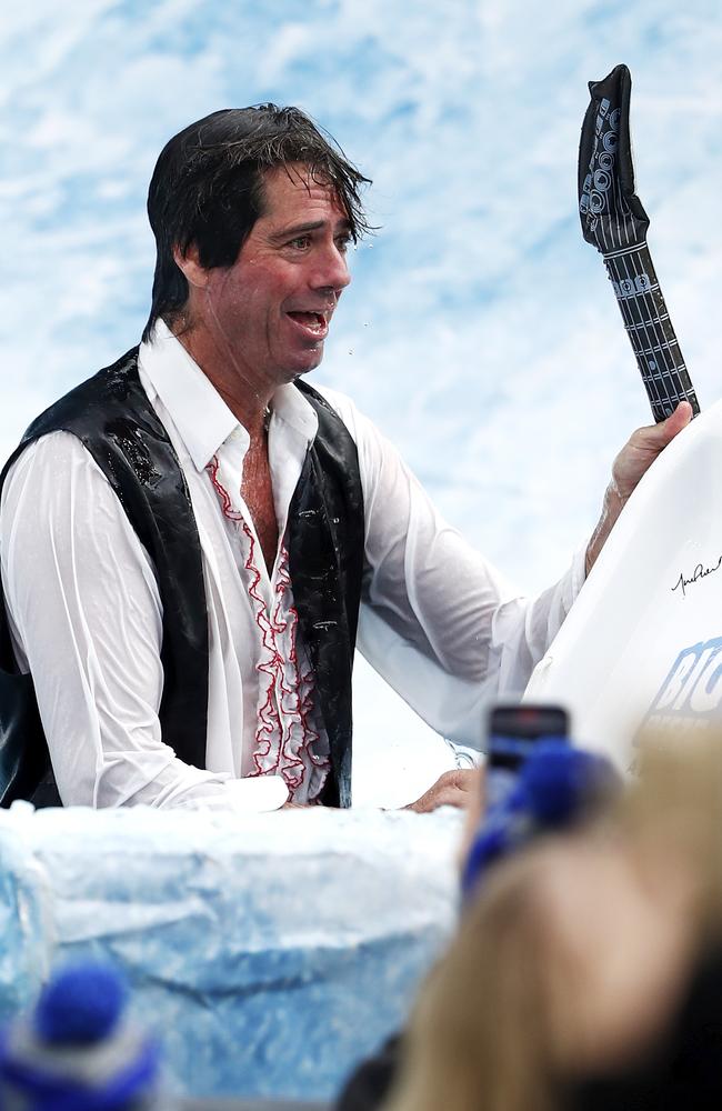 The soaked executive makes his way out of the pool. Picture: Dylan Burns/AFL Photos