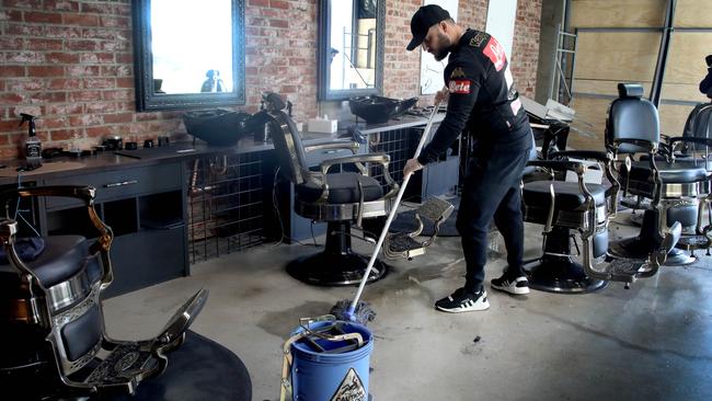Owner MJ Casalbore cleans up at his Norwood shop on Thursday morning. Picture: Dean Martin