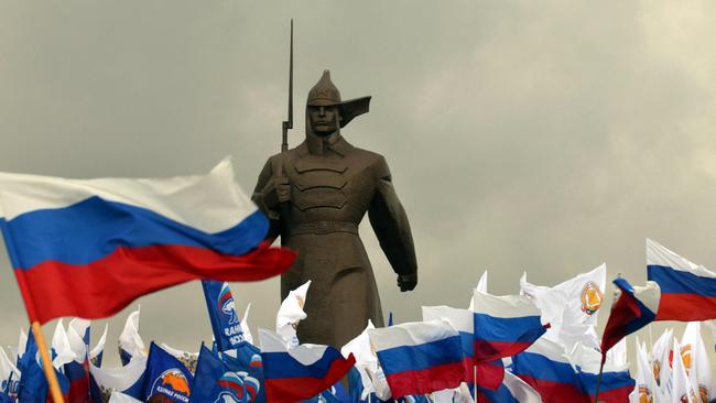 Pro-Kremlin activist hold Russian flags near a monument to Red Army soldier as they rally in the southern Russian city of Stavropol.