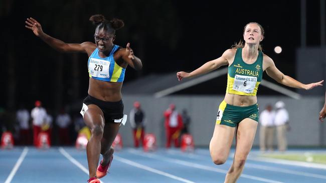 Julien Alfred of Saint Lucia crosses the finish line to win the Girls 100m Final ahead of Riley Day.