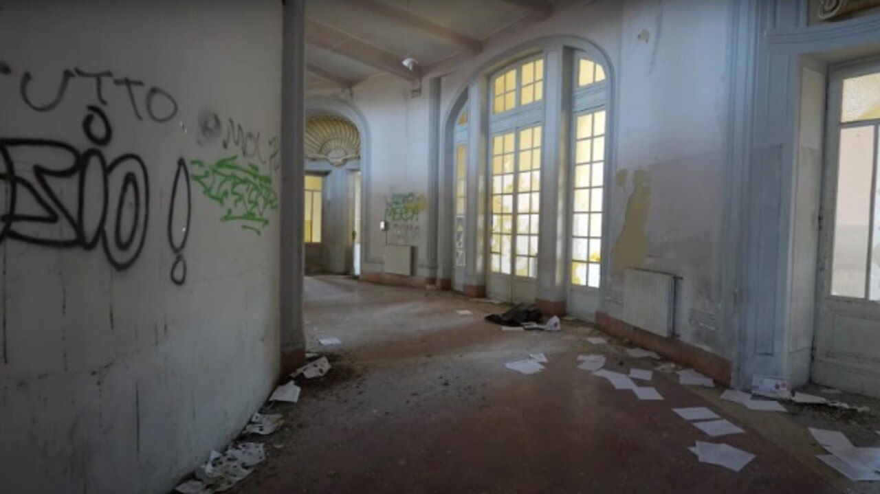 Graffiti, broken doors and pieces of unwanted paper have trashed the once luxury building. Picture: YouTube/abandonedcentral