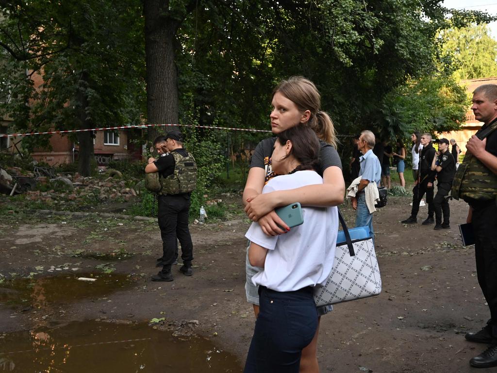 Local residents react outside a five-storey residential building partially destroyed after drones attacks killed two and wounded 19 in eastern Ukrainian city of Sumy on July 3, 2023, the regional administration said. Picture: SERGEY BOBOK / AFP