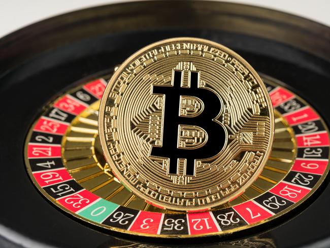 Gdansk, Poland - 11 September 2018: Gold physical Bitcoin coin on casino roulette. Crypto currency market gambling abstract concept.