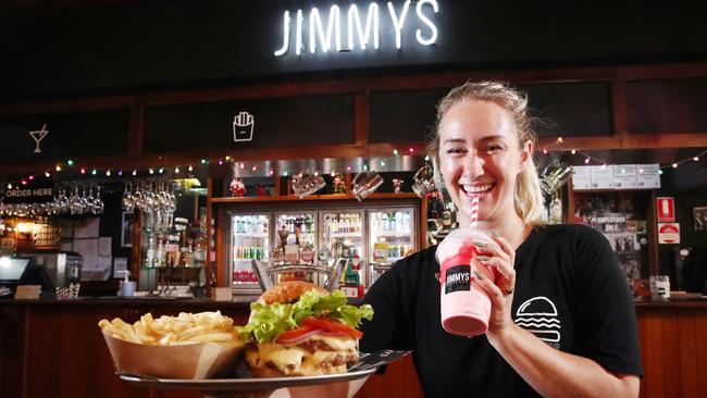 Jimmy's Burger and Co assistant manager Jen Bell serves up a Jimmy's classic double patty burger, fries and a strawberry milkshake. Picture: Brendan Radke