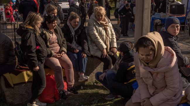 Civilians wait for news of relatives after their residential building was bombed by Russia. Picture: Roman Pilipey/Getty