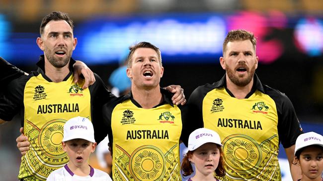 Glenn Maxwell, David Warner and Aaron Finch belt out the national anthem at The Gabba. Picture: Bradley Kanaris/Getty Images