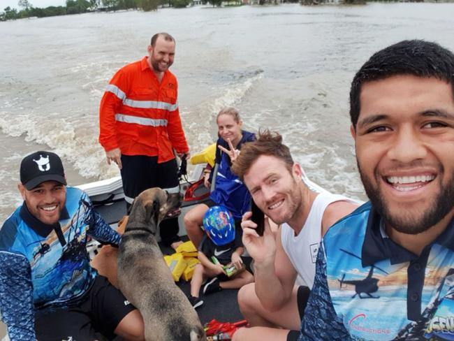 North Queensland Cowboys Twitter image of John Asiata, Antonio Winterstein, Gavin Cooper and club chaplain Aaron Mealing out rescuing both people and dogs today in the Townsville floods.