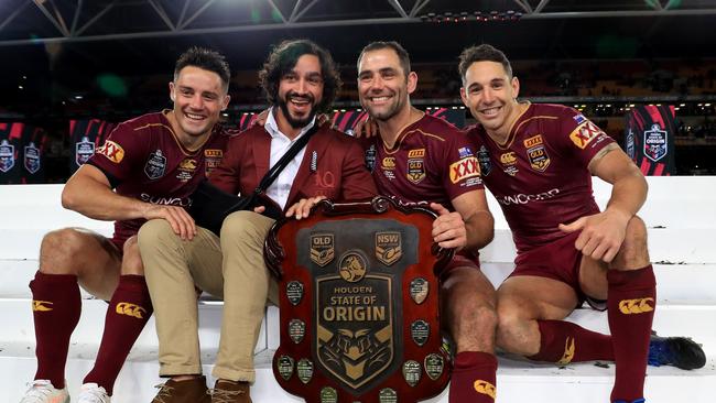 Cooper Cronk, Johnathan Thurston, Cameron Smith and Billy Slater hold the shield up to celebrate winning the Origin decider between Queensland and NSW at Suncorp Stadium in Brisbane. Pics Adam Head