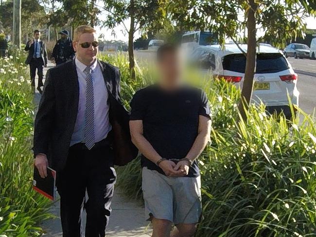 Officers make an arrest in relation to the alleged scam. Photo: NSW Police Force